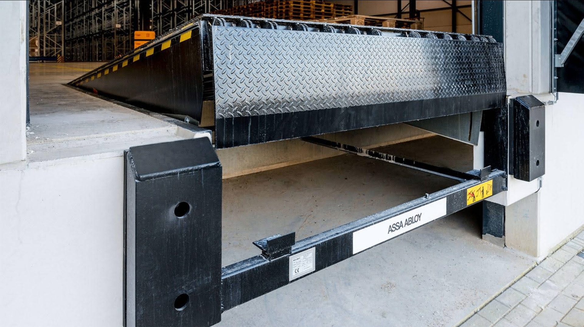 Commercial loading dock leveler installed at a warehouse bay